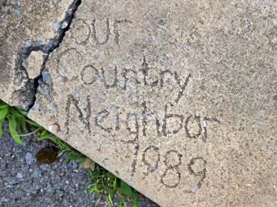 "Our Country Neighbor" written in the cement, dated 1989.  This could have been the original construction of the building, or at least the last time the sidewalk was done.  Either way, I found it interesting.