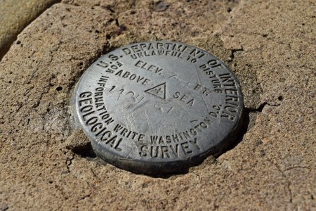 USGS benchmark next to the entrance to the store.