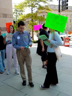 A woman passes out literature out to the marchers, which provide further information on the cause.