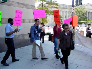 Protesters marching in circles on the corner.