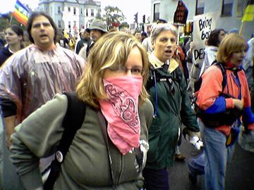 We also encountered a number of masked protesters in the crowd, who went masked for various reasons. The girl in the pink bandanna actually commented to me, "This is why I cover my face at these events," after I took her picture (with permission) during the march.