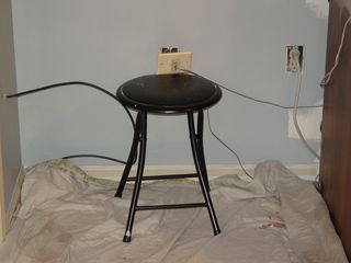 I had no idea that the phone jack was ATTACHED to the plate until I removed it. That was a pain in the butt to paint around, and even more to put somewhere while the paint dried, since it had a range of only inches. So I put it up on this stool, where it will stay until the paint dries and I can reattach it.