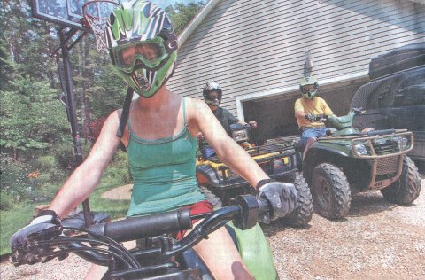 Lauren Sohn rides the ATV while wearing short shorts and a tank top