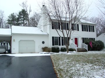 The house as seen from the end of the driveway, with snow on the roof and in front. As you can see, this isn't a whole lot of snow by any means at this point.