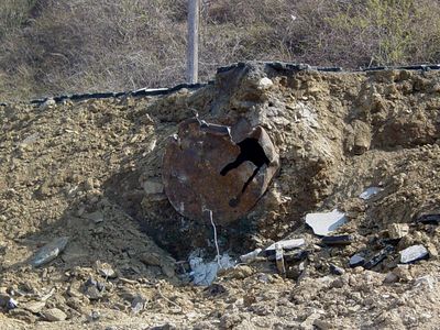 I would be interested to find out what this metal, man-made object embedded in the ground is.