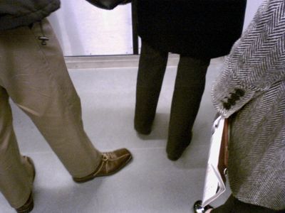 The feet of commuters about to get off at Dupont Circle on the new flooring.