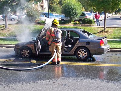 Hosing down the car's interior with the foam.