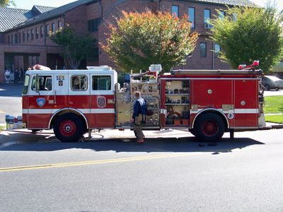 One of about three fire trucks in front of a nearby church.