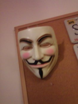 Guy Fawkes mask hanging from the wall