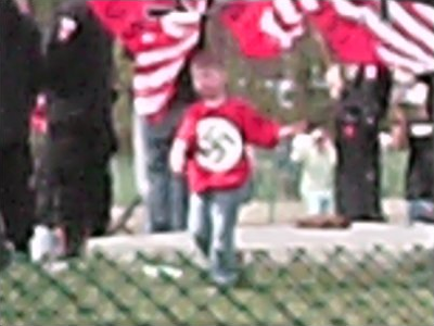 Child wearing swastika t-shirt