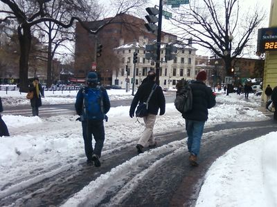 People walking through the U-turn area on Connecticut Avenue because the sidewalk wasn't clear.