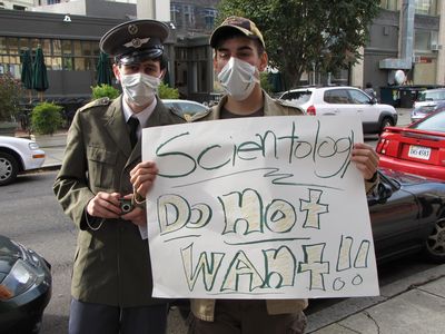 Anons with signs outside the Founding Org.