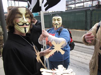 MaidofWin hands out cardboard Scientology crosses.