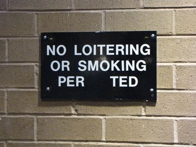 "No smoking or loitering per Ted". Okay. I suppose if this anonymous Ted person said so, it is so. The sign originally said "No smoking or loitering permitted", but someone apparently had their way with the "mit" in the middle. Either way, though, it was amusing.