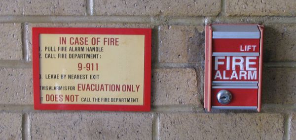 Then this was the pull station configuration. They had "lift" pull stations, and a notice next to them instructing would-be heroes that the alarm does not automatically call the fire department, and that the fire department must be called separately.