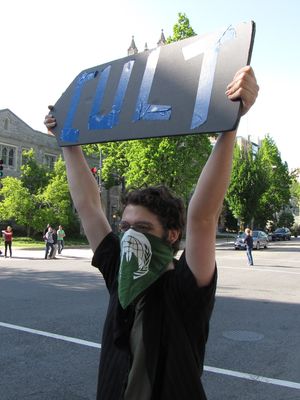 Of course, that didn't stop our Anon, who later was holding up our "cult arrow" sign.
