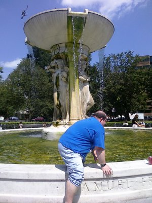 Climbing into the fountain.