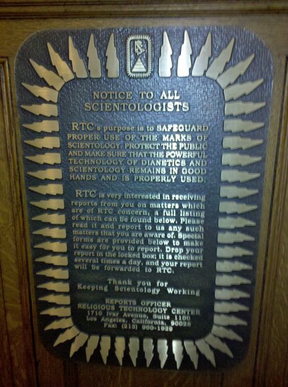 This plaque, a "NOTICE TO ALL SCIENTOLOGISTS", located in the main stair on a landing between the second and third floors, briefly explains the purpose of the Religious Technology Center (RTC), basically as a keeper of Scientology, to prevent its misuse, and to prevent others from using it outside of the official organization. Then it encourages people to report to the RTC anything that they might be concerned about. My take is that it kind of encourages Scientologists to rat out their peers to the RTC. A little Nazi-like, no?