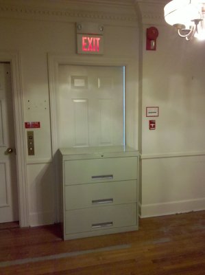 Fire exit deliberately blocked by a file cabinet