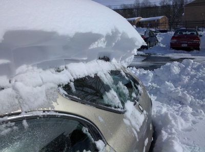 I'm finding a car under all this. Again note the sheer amount of snow piled on top of the car. I doubt I'll be moving that pile on top any time soon. I'm hoping to like shed all that while driving, and hope that it falls backwards when it does.