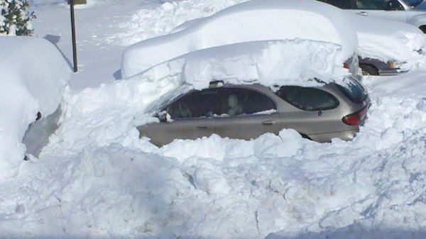 So there you go. I've cleared all the side windows, the back window, and part of the windshield. Hopefully that will be enough to at least allow the sun to reach the inside of the car and warm it up a little. If the interior is warmer, that will hopefully melt the bottom layer of snow on the windshield and make it easier to remove later.