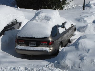 Figures. Just as soon as I clear the ice off the car, I get another foot dumped on it. Note the large block of snow still on the roof from the first snowfall that I didn't clear just sitting high around the rest of the new snow.