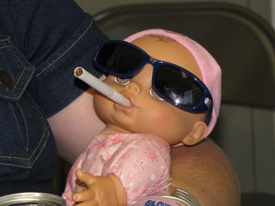 The doll has a cigarette.