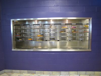 Changes to the tray return area to accommodate the elimination of trays.  The window is enlarged, and a plate hopper is added.