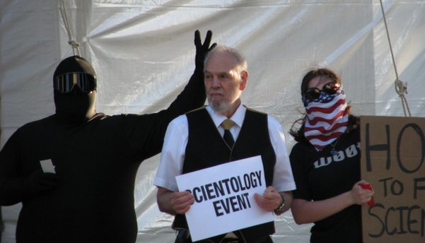 Giving rabbit ears to a Scientologist on the corner.