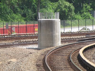 Apparently, the unused bridge pier for the eventual Silver Line (N Route) connection has been refurbished in preparation for its actual use with the line to Dulles. It was light gray in color, and the rebar coming out of the top was shiny. Previous photos of that stub (from 2004 and from 2006) showed that same object as being brown in color, and the rebar was dark.