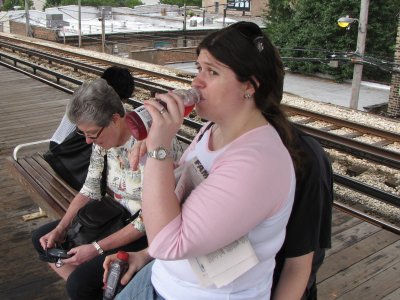 Ann Lysy has a drink on a Chicago "L" train platform