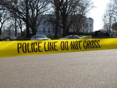 That is the White House in the background, and then police tape in the foreground. I like it because it conjures up the idea of "Show me what a police state looks like! This is what a police state looks like!" without saying it explicitly.