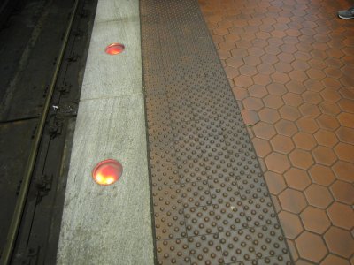 Well-lighted platform edge at Gallery Place lower level.