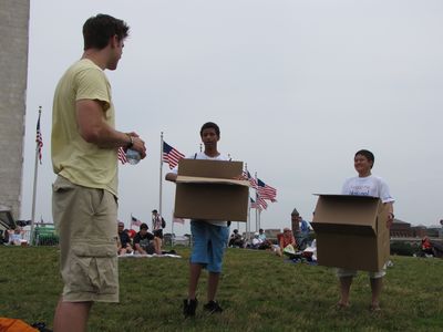 Jory talks to two kids carrying empty boxes that previously contained National Mall shirts. They recognized Jory from YouTube as well.