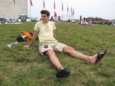 Jory sits on the grass in front of the Washington Monument.