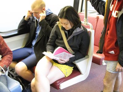 The idea of this ride was really just to "act natural" without pants. Thus this woman took to reading a book...