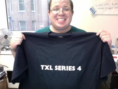 Holding up my "TXL SERIES 4" shirt