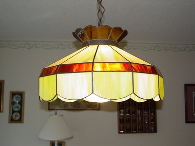 This is the light in my parents' dining room. My parents have had this stained glass light fixture since before I was born. They got it in New Jersey, we brought it with us to Arkansas where it was on a very long chain from hooks in the ceiling and down the wall to a plug, and then since 1992 it has hung in our house in Stuarts Draft on a much shorter chain. I don't understand the significance of this light fixture to this day, but they did pass up a new modern fixture when the house was built in order to use this one. Why did I photograph this, though?