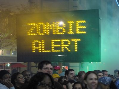 Normally this would be illegal (like in this case), but this time, they actually set a sign board up and rotated through several messages: "ZOMBIES!", "ZOMBIE ALERT", "THIS IS **NOT** A DRILL", "UN-DEAD AHEAD", and "HIDE YOUR BRAINS". Classic.