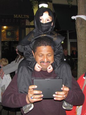  This was adorable, with a child dressing up as a ninja. Meanwhile, the father appears to have found something far more interesting on that BlackBerry tablet than the zombies in front of him.