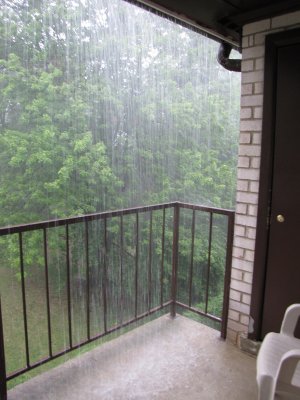 The rain coming off the gutters and down onto the balcony.