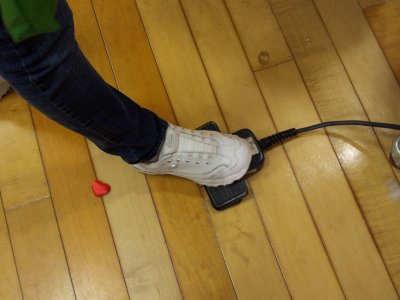 Mom uses the foot pedal that controls the flow of stuffing.