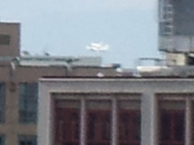 Highly zoomed in image of Discovery riding piggyback on the airplane as it buzzes the Mall (my building is in Dupont Circle, north of the Mall).