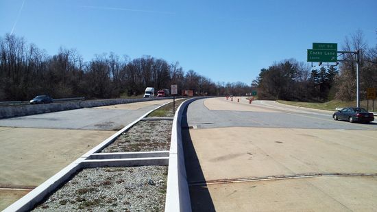 Taken from approximately the same location as the previous photo but facing the other way. This is the area where eastbound traffic (at left) enters the park and ride, and where westbound traffic (at right) departs the park and ride.