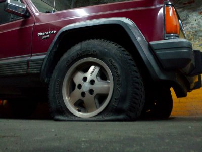 Flat tire on a vehicle in a parking garage in Baltimore, Maryland.