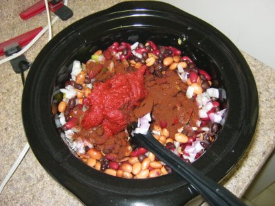 Chili powder and tomato paste in the pot. I think I put a lot of chili powder in, and that makes me slightly nervous. I hope I didn't overdo it. I wanted to make sure it was spicy, though, and I think I've got that covered.