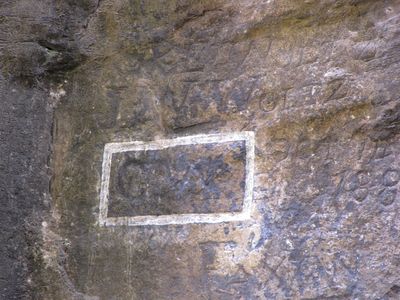 Back in the 1700s when surveying the area, then-future president George Washington left his initials on the rock.  The white box highlights Washington's initials.
