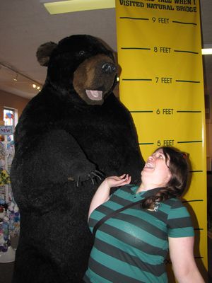 Sis does similarly, first posing with the height measure (the gist of it is to show how tall you were when you visited Natural Bridge), and then acting scared with the bear.