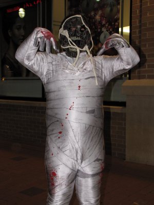 A child went as a zombie mummy.  I believe that this outfit is a zentai suit printed with a bandage pattern on it, with the hood part down.