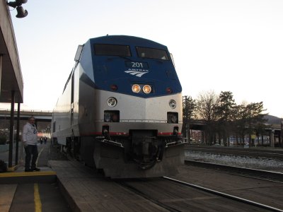 The Amtrak employee on site at Cumberland interacts with the people on the locomotive.